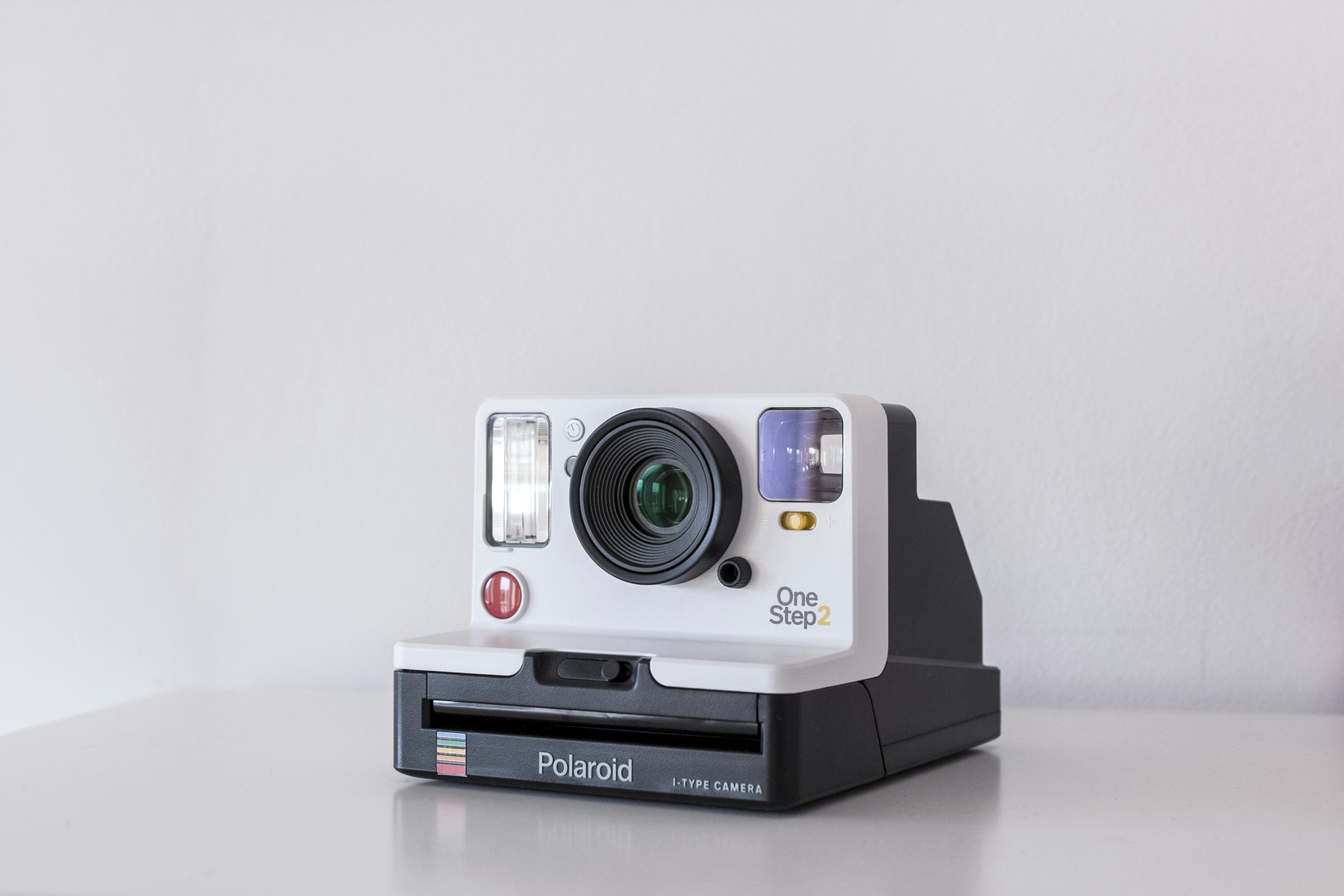 Side-by-side comparison of a camera setup in a physical photography studio versus a clean digital product cutout on a laptop screen